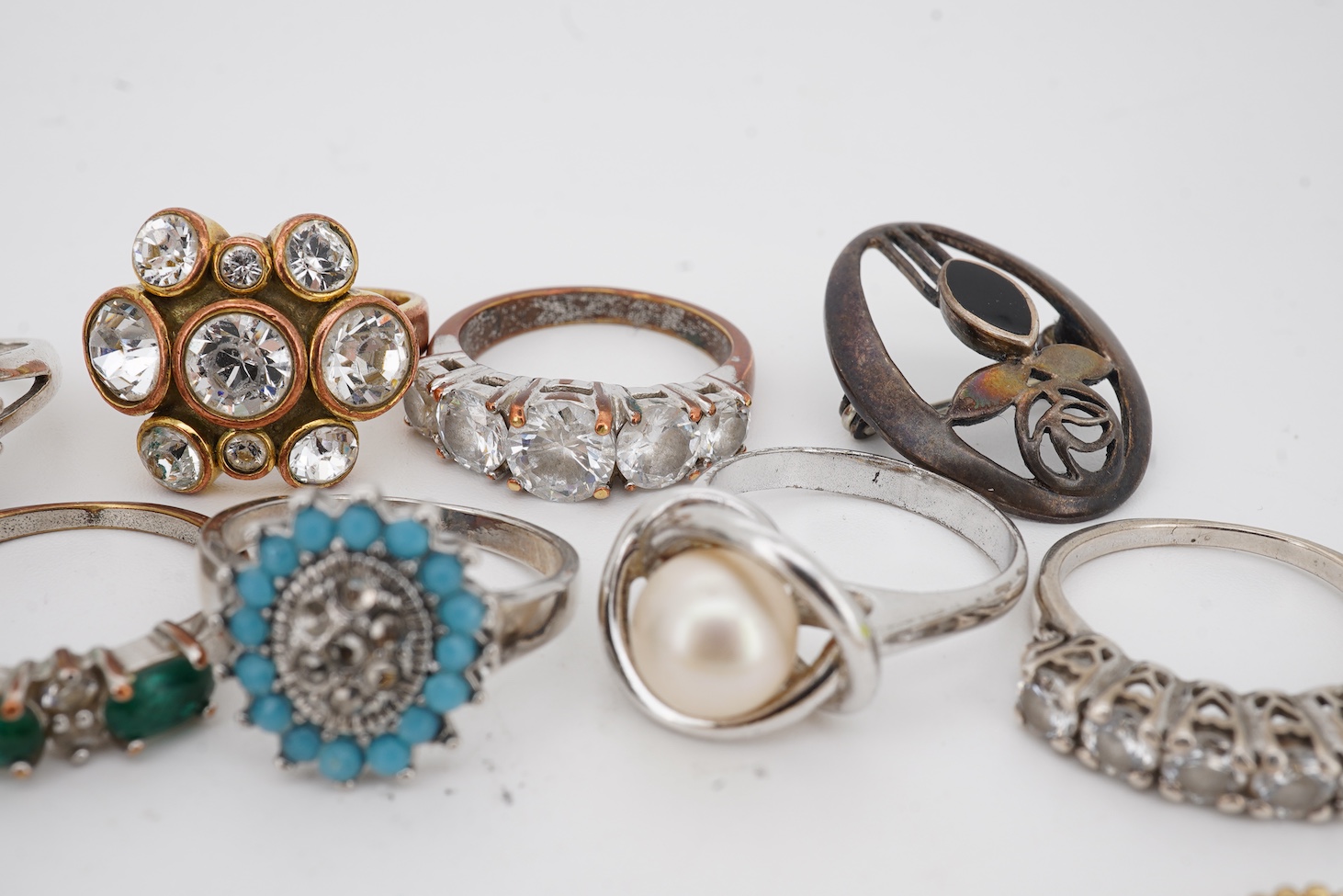 Assorted jewellery including a 925, black onyx and marcasite set Art Deco style ring, three other 925 rings, a pair of 925 amber ear studs and a 925 brooch, together with four costume rings and a costume bracelet.